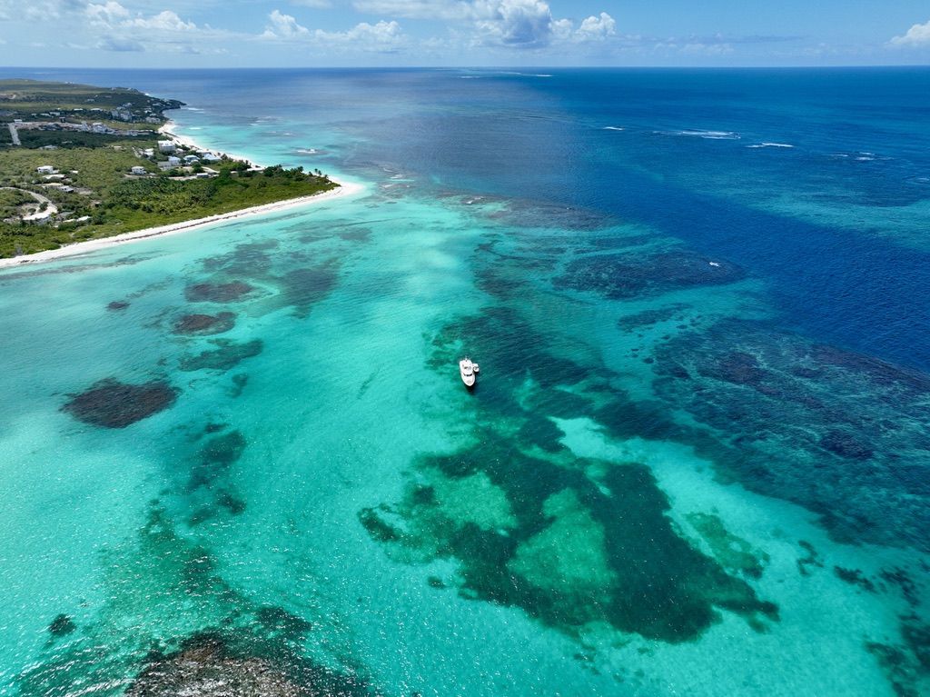 Aerial view of the turquoise reef and coastline at Shoal Bay East, Anguilla